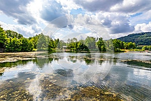 Echternach lake in panoramic nature landscape, algae and reflections on water surface
