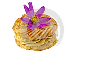 Eclair with butter cream decorated with a flower on a white background