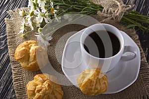 Eclair, coffee cup and charmomile.