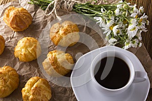 Eclair, coffee cup and charmomile.