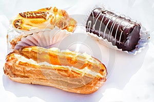 Eclair or palo, Swiss roll or brazo de gitano and cream pastry or pastel de crema photo