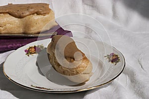 Coffee flavored eclair on a plate