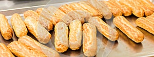 Eclairs on a baking sheet. Selective focus.