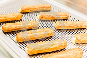 Eclairs on a baking sheet. Selective focus.