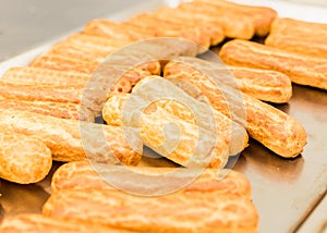 Eclairs on a baking sheet. Selective focus.