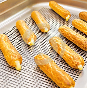 Eclairs on a baking sheet. Selective focus.