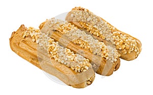 Eclairs with pieces of peanuts isolated on white