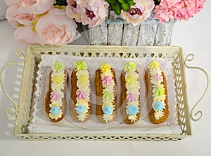 The eclairs with vanilla cream cheese decorated with merengues
