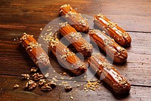 Eclairs on wooden table close up