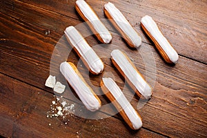 Eclairs on wooden table close up