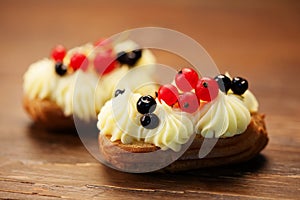 Eclairs on wooden table close-up