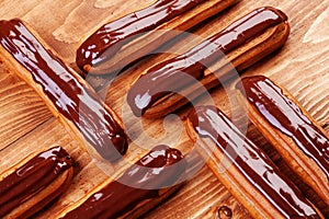 Eclairs on wooden table close up