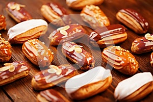 Eclairs on wooden table close up