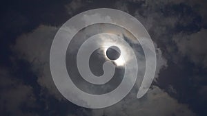 The eclipse of the sun on April 8th 2024 with a slight cloud cover to show the corona photo