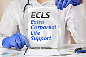 Doctor holding a tablet with text: ECLS. ECLS Extra Corporeal Life Support, medical concept photo
