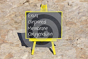 ECMO Extra Corporeal Membrane Oxygenation symbol. Concept words ECMO Extra Corporeal Membrane Oxygenation on black chalk