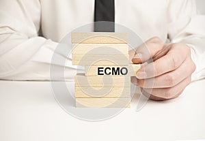 ecmo word letters on wooden blocks with coins and chart. Career employment concept