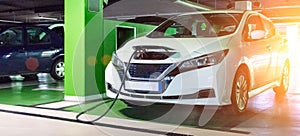 Eco auto. Electric car charge battery on eco energy charger station. Hybrid vehicle - green technology of future. Clean energy