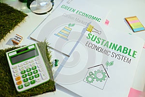 Eco aware business. calculator and documents at table