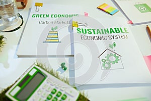 eco aware business. calculator and documents at table