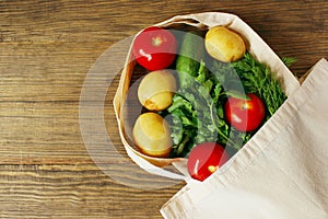 Eco bag and colorful vegetables on a wooden background. Zero waste, eco friendly, no plastic. Recycling concept eco-friendly.