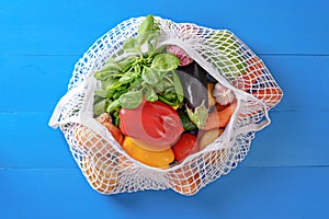 Eco bag with vegetables on blue background, online food shopping, donates, online marketplace
