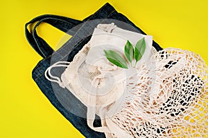 Eco Bags.Sustainable lifestyle.A variety of eco bags on a yellow background . Zero waste minimal composition with tring