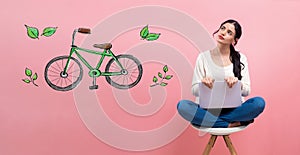 Eco bicycle with woman using a laptop