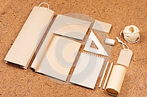 Eco blank packaging, stationery, gifts template of kraft paper on brown coconut fiber background, tilt.