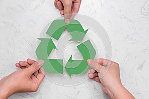 Eco concept. Paper recycle sign in hands