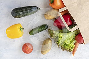 Eco concept for shopping, food preparation. paper bag with carrots, cucumbers, bell peppers, patatoes, lettuce and