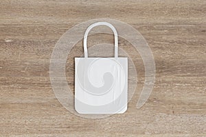 Eco concept with white natural texture white shopping bag on wooden surface. 3D rendering