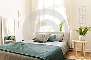 Eco cotton linen and blanket on a bed in nature loving family guesthouse for spring and summer vacation. Real photo. photo