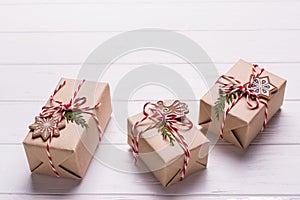 Eco craft holidays gift boxes tied with red and white string on black background