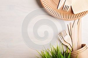 Eco disposable picnic tableware, takeaway food, paper plates and wooden knives, forks, copy space