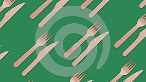 Eco, disposable takeaway wooden cutlery fork, knife on green background. Plastic free, biodegradable, green screen, looping