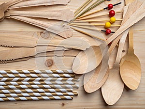 Eco, environment friendly disposable cutlery made from bamboo on wooden rustic background, top view