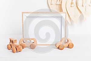 Eco fiendly child wooden toys and mockup frame in baby room interior