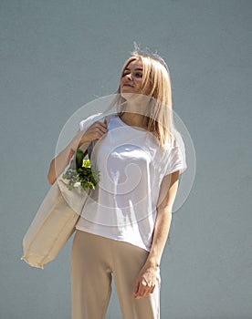 Eco food idea. Smiling young woman with Grocery Bag Full With Fresh Bio Vegetables food on a street