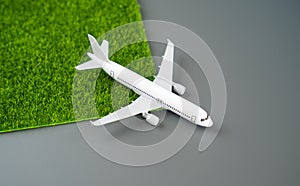 Eco-friendly airlines. The plane leaves a trail of green grass behind it. photo