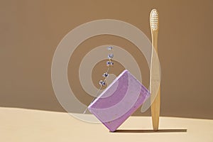 Eco friendly bamboo toothbrush and Handmade aromatic spa lavender soap. Natural additives and extracts. Bar of lavender