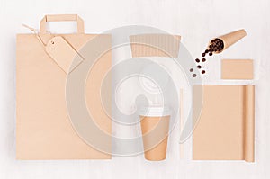 Eco friendly coffee template for design, advertising and branding - brown paper cup, blank bag, notebook, label, coffee beans.