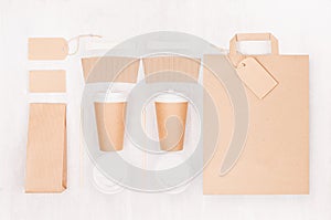 Eco friendly coffee template for design, advertising and branding - two brown paper cups and blank bag, packet, label, card, cap.