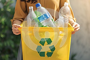 Eco friendly concept woman recycles plastic bottle in home recycling bin