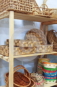 Eco-friendly goods, home space organization and storage, various natural straw wicker baskets stand on a shelf on a