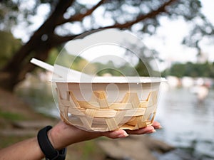 eco friendly  Organic bagasse bowl for single used in hand on blur background