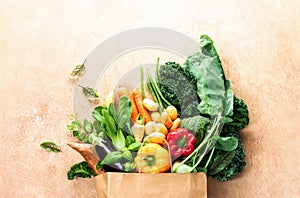 Eco friendly paper bag full of fresh organic farmers market vegetables