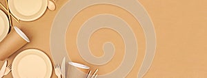 Eco friendly, plastic free disposable dishware for takeout. Corner border on a brown paper background.