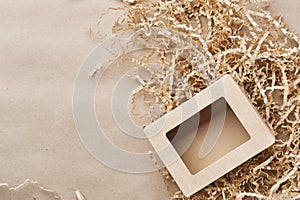 Eco-friendly shipping packaging on brown paper background with copy space