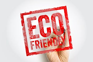 ECO FRIENDLY shown as a bold stamp held by a hand, creating a textured framed mark that highlights sustainability and